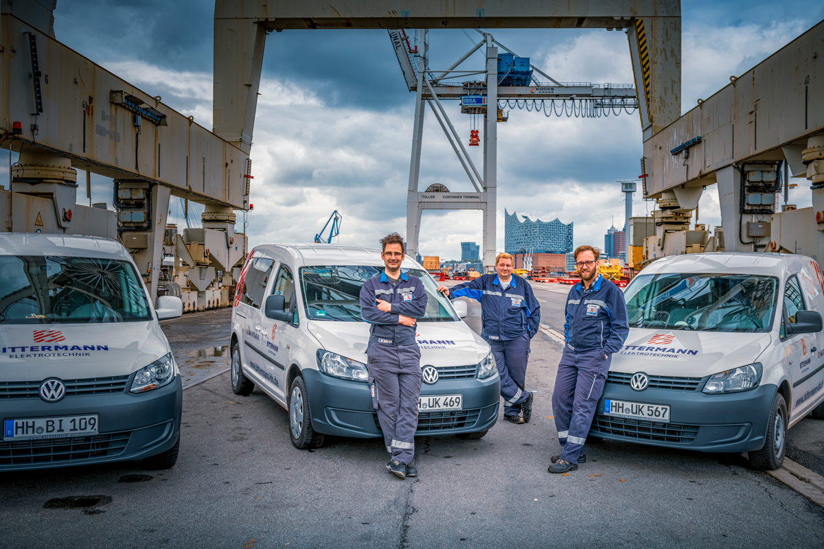 Electricians with company vehicles
